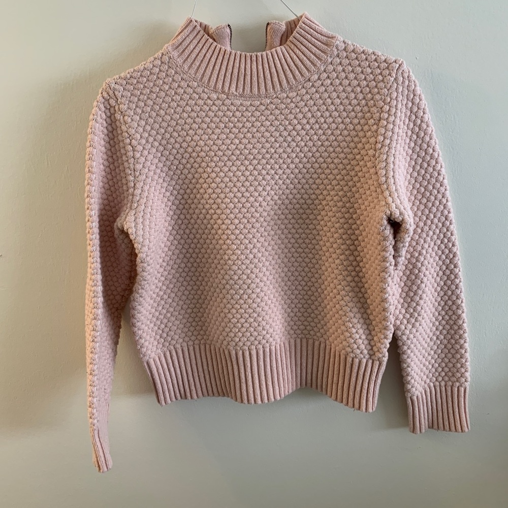 A textured pink sweater